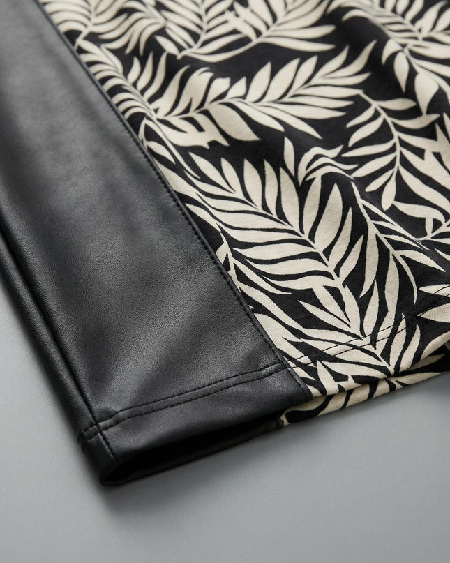 Κοντινή λεπτομέρεια υφάσματος από επίσημη τουνίκ σε μεγάλα μεγέθη, εστιάζοντας στον συνδυασμό μαύρης δερματίνης και μοντέρνου μοτίβου με φύλλα.