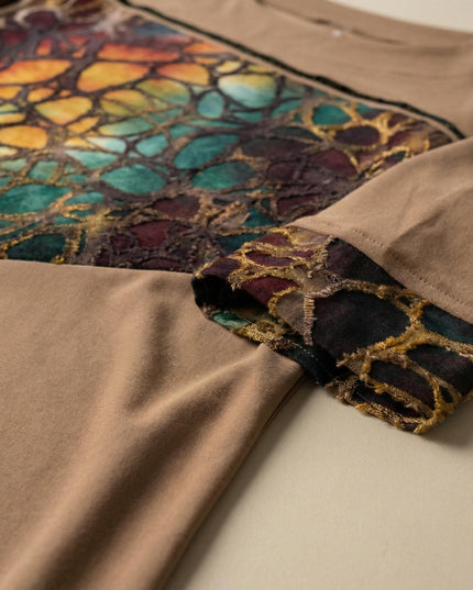 Κοντινή λεπτομέρεια από επίσημη καφέ τουνίκ που εστιάζει στο πολύχρωμο εμπριμέ σχέδιο στο μανίκι και την υφή του υφάσματος, σε μεγάλα μεγέθη.