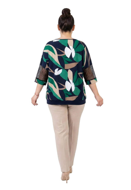 Πίσω όψη από την επίσημη καλοκαιρινή τουνίκ plus size. Φαίνεται το σκούρο μπλε ύφασμα με το χρωματιστό σχέδιο φύλλων και τα διχτυωτά μανίκια.