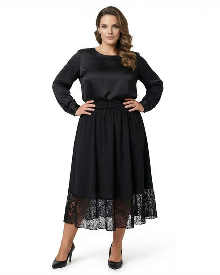 Μοντέλο φοράει επίσημη μαύρη μάξι φούστα σε μεγάλα μεγέθη με τελείωμα δαντέλας. Ολόσωμη λήψη σε λευκό φόντο.