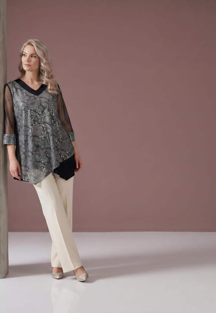 Ολόσωμη λήψη, επίσημη μαύρη τουνίκ plus size με λαμπερό ασημένιο πάνελ, V λαιμόκοψη και διαφανή τούλινα μανίκια.