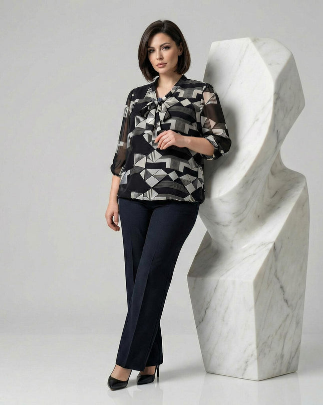 Επίσημη μαύρη τουνίκ σε μεγάλα μεγέθη με λευκό γεωμετρικό μοτίβο, φιόγκο στη λαιμόκοψη και άνετα μανίκια 7/8, σε κομψή ολόσωμη λήψη.