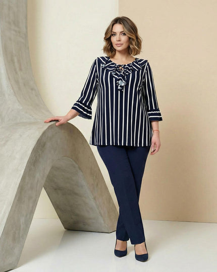 Ολόσωμη λήψη από κομψή επίσημη ριγέ τουνίκ σε μεγάλα μεγέθη, με κάθετες ρίγες, μανίκια 7/8 με βολάν και κορδόνια στο ντεκολτέ.