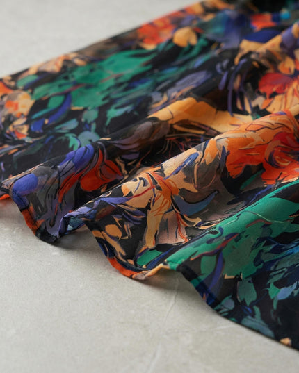 Κοντινή λεπτομέρεια που αναδεικνύει την υφή και το χρωματιστό σχέδιο στο αέρινο εβαζέ φόρεμα σιφόν για μεγάλα μεγέθη.