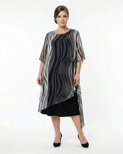 Επίσημο μαύρο φόρεμα plus size σε ολόσωμη λήψη, με αέρινη ασύμμετρη μουσελίνα και ντεγκραντέ κυματιστό σχέδιο σε γκρι και λευκούς τόνους.