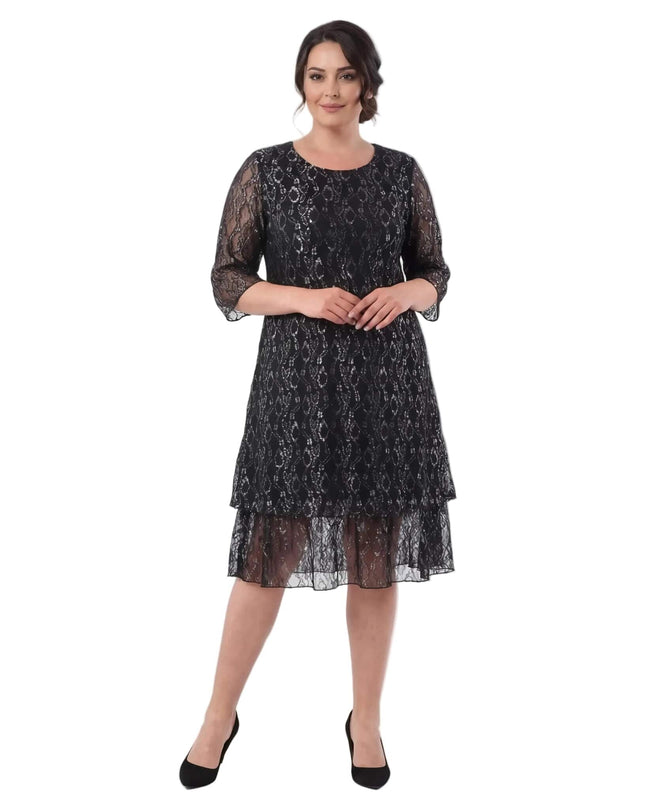 Ολόσωμη λήψη σε λευκό φόντο με επίσημο μαύρο φόρεμα σε μεγάλα μεγέθη, διακοσμημένο με εντυπωσιακή δαντέλα και μανίκια 3/4.