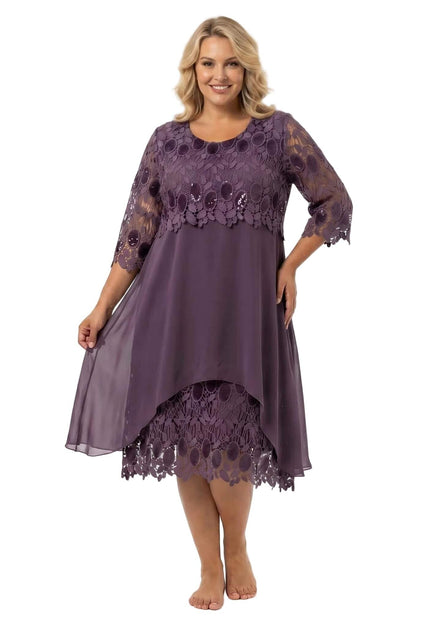 Ολόσωμη λήψη: Επίσημο plus size φόρεμα σε σάπιο μήλο με ανάγλυφη δαντέλα, 3/4 μανίκια και αέρινο ασύμμετρο σιφόν, σε λευκό φόντο.