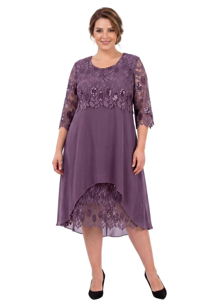Ολόσωμη λήψη: Επίσημο plus size φόρεμα σε σάπιο μήλο, με κομψό δαντελένιο μπούστο, 3/4 μανίκια και ασύμμετρη αέρινη φούστα από σιφόν.