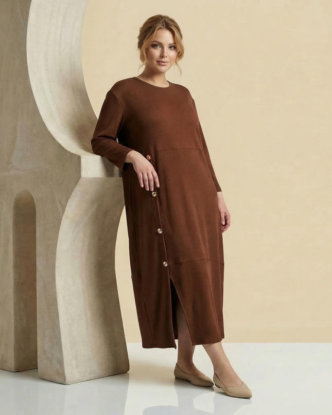 Ολόσωμη λήψη: Επίσημο καφέ plus size μάξι φόρεμα με ριπ υφή, μανίκια 7/8, διακοσμητικά χρυσά κουμπιά και σκίσιμο.