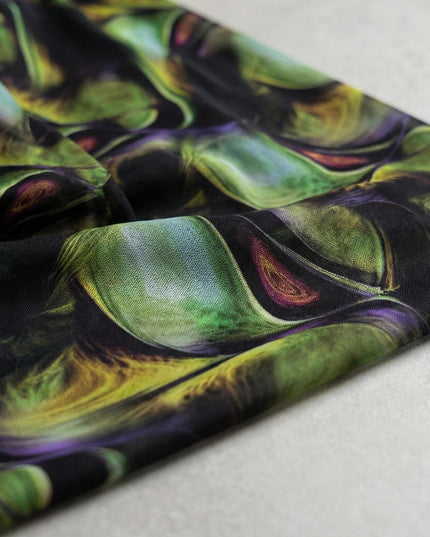 Κοντινή λεπτομέρεια του υφάσματος από επίσημο σιφόν φόρεμα με αφηρημένο πολύχρωμο μοτίβο σε μαύρο φόντο με πράσινες και μωβ αποχρώσεις, για μεγάλα μεγέθη.