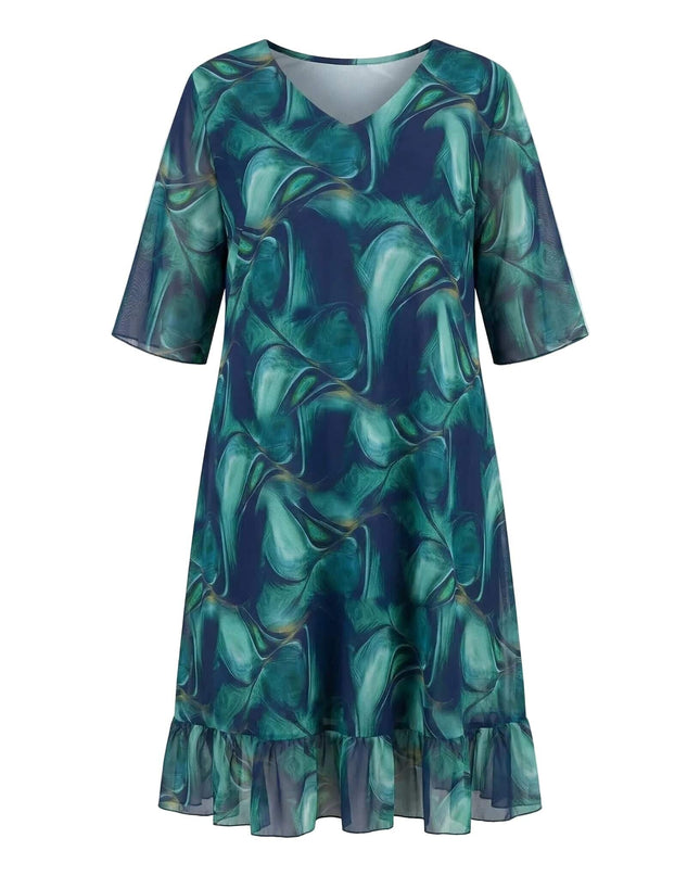 Επίσημο σιφόν φόρεμα σε μεγάλα μεγέθη, με αφηρημένο σχέδιο σε μπλε αποχρώσεις, V-ντεκολτέ και βολάν. Μπροστινή όψη σε λευκό φόντο.