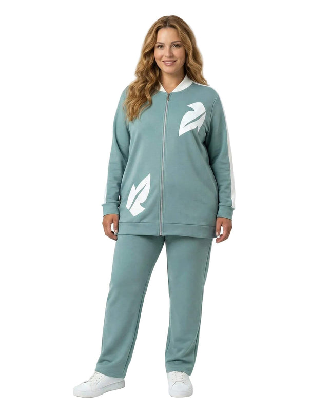 Γυναικείο plus size σετ δύο τεμαχίων σε ανοιχτό πράσινο, με λευκές λεπτομέρειες φύλλων από οικολογικό δέρμα στο σακάκι και άνετη εφαρμογή, σε ολόσωμη λήψη.