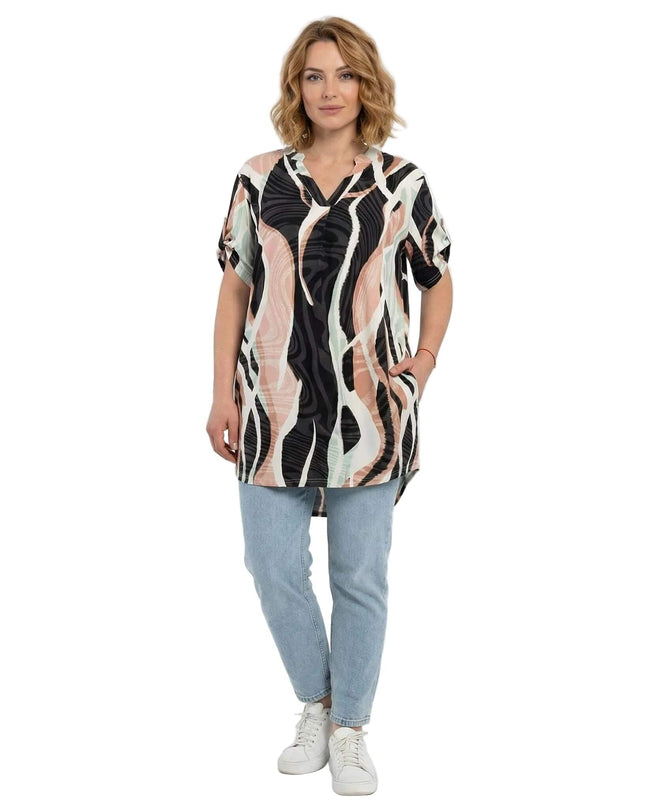 Μπροστινή όψη μιας plus size μακριάς τουνίκ με πολύχρωμο αφηρημένο μοτίβο και V-λαιμόκοψη. Ολόσωμη λήψη μοντέλου σε λευκό φόντο.