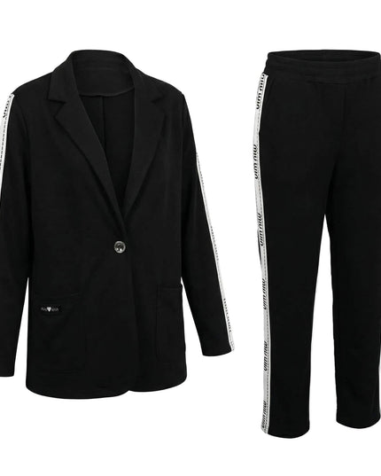 Μαύρο καθημερινό γυναικείο σετ σακάκι και παντελόνι σε μεγάλα μεγέθη, με λευκή διακοσμητική ρίγα στα πλαϊνά, φωτογραφημένο σε λευκό φόντο.