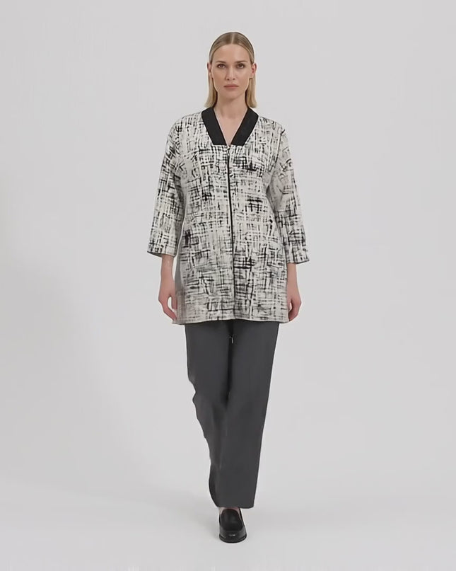 Βίντεο σε περιβάλλον στούντιο που δείχνει ένα μοντέλο να περπατάει αργά προς την κάμερα φορώντας Γυναικεία μπεζ plus size ζακέτα με φερμουάρ και αφηρημένο σχέδιο