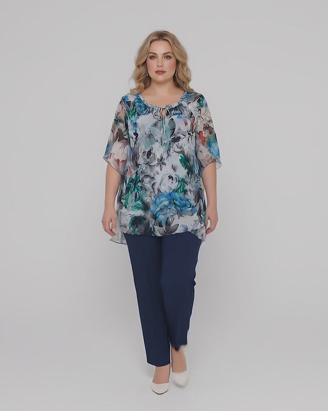 Σε περιβάλλον στούντιο ένα plus-size γυναικείο μοντέλο περπατάει αργά προς την κάμερα φορώντας την Κομψή επίσημη γυναικεία τουνίκ σε μεγάλα μεγέθη
