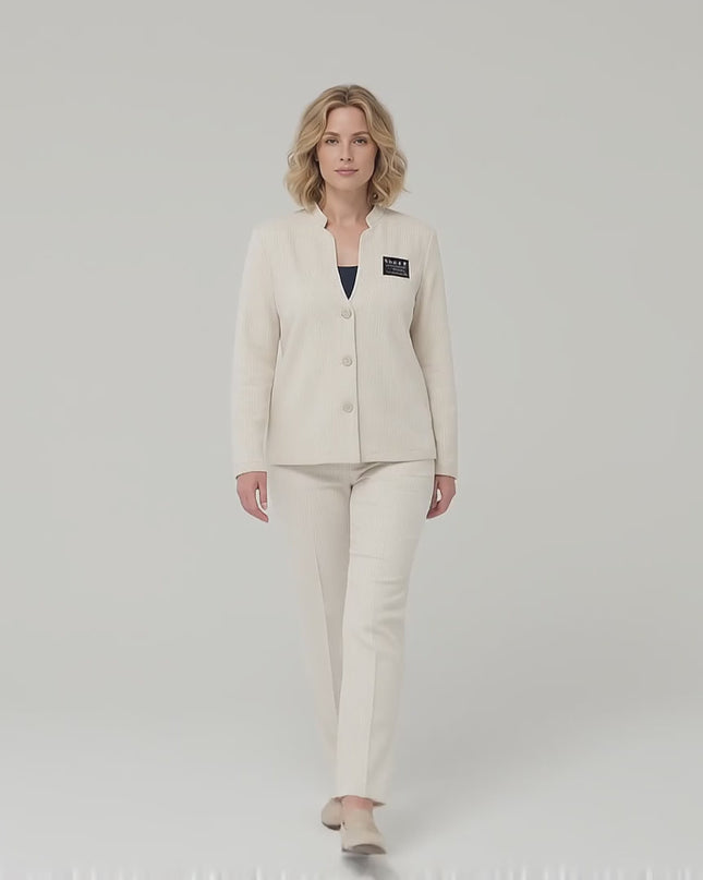 Ένα plus-size μοντέλο περπατά αργά προς την κάμερα σε περιβάλλον στούντιο με ουδέτερο φόντο, φορώντας το Επίσημο μπεζ γυναικείο σακάκι με εντυπωσιακό ντεκολτέ σε μεγάλα μεγέθη