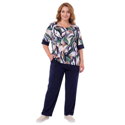 Γυναικείο plus size σετ με σκούρο μπλε παντελόνι και τουνίκ με print φύλλων. Ολόσωμη λήψη με το μοντέλο σε λευκό φόντο.